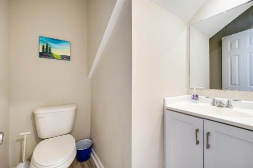 a bathroom with a toilet and a sink and a mirror at Wilmington Getaway Near Riverwalk and Downtown! in Wilmington