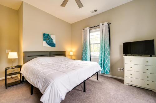 a bedroom with a bed and a tv and a window at Wilmington Getaway Near Riverwalk and Downtown! in Wilmington