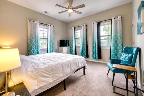 a bedroom with a bed and a blue chair at Wilmington Getaway Near Riverwalk and Downtown! in Wilmington