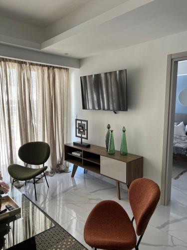 a living room with a desk and two chairs at Cozy condo beach acsess cap cana in Punta Cana