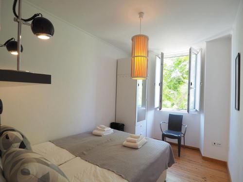 a bedroom with a bed with two towels on it at Mosteiro - Lissabon Altstadt in Lisbon