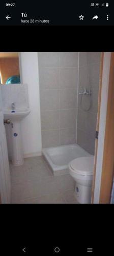 ein Badezimmer mit einer Badewanne, einem WC und einem Waschbecken in der Unterkunft Cabañas El Milagro in Coquimbo