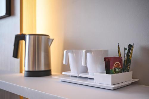 a shelf with two coffee makers on it at Holiday Inn Express - Astana - Turan by IHG in Astana