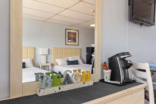 a bedroom with a bed and a tv and a mirror at Mt Royal Motel in Old Orchard Beach