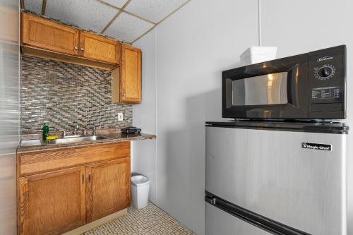 a kitchen with a microwave on top of a refrigerator at Mt Royal Motel in Old Orchard Beach