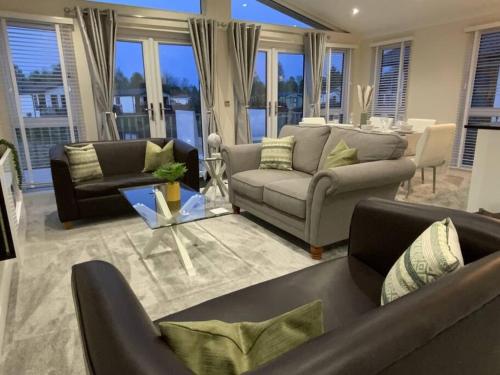 a living room with two couches and a table at Elora's Dream in Wisbech