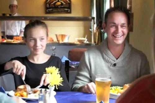 a man and a woman sitting at a table eating food at Elora's Dream in Wisbech