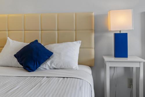 a bed with a blue pillow and a blue lamp at Mt Royal Motel in Old Orchard Beach