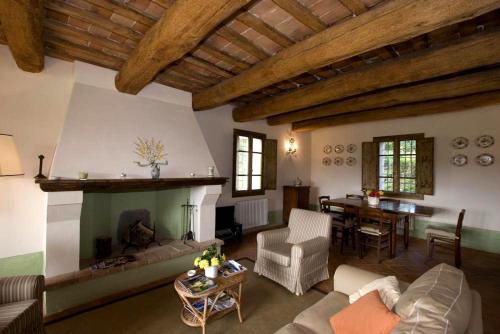 a living room with a couch and a fireplace at Villa Il Cigno in Brisighella