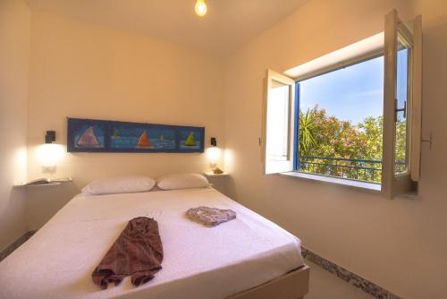 a bedroom with a large bed with a window at Dimore di mare - Beachfront Apartments in Santa Flavia