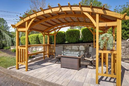a wooden gazebo in a garden with a table at Quakertown Vacation Rental Close to Hiking Trails in Quakertown