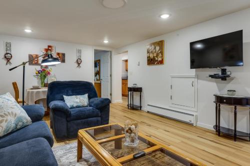 a living room with a couch and a tv on a wall at Quakertown Vacation Rental Close to Hiking Trails in Quakertown