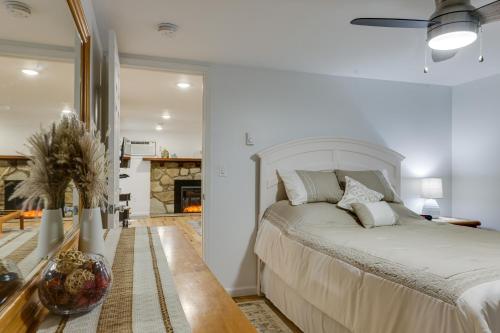a white bedroom with a bed and a fireplace at Quakertown Vacation Rental Close to Hiking Trails in Quakertown