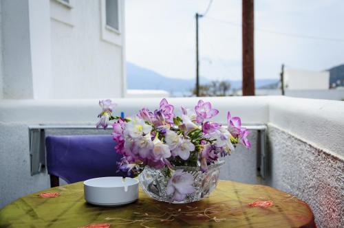 a vase of flowers sitting on a table at Christina Rooms in Adamas