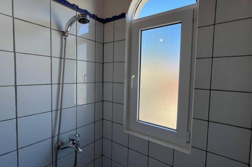 a bathroom with a shower and a window at Cabarete Beach Apartment in Cabarete