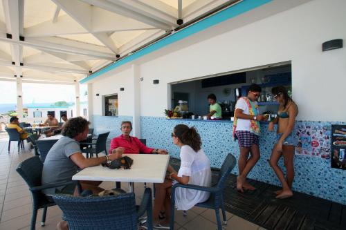 a group of people sitting at a table in a restaurant at Bikini Hotel in Vieste