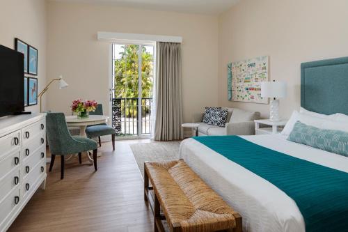 a hotel room with a large bed and a television at The Capri Inn in Naples