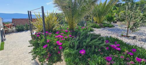 a garden with purple flowers and plants at Luxury White Sails Villas with a Multi Sport Court #2026# and Sea View in Pinezici