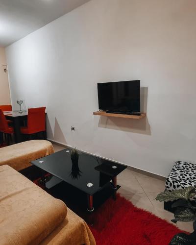 a living room with a tv on a white wall at Mountain View in Konitsa