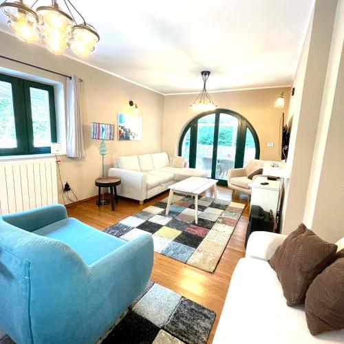a living room with a blue couch and a table at Villa Muraj-Kornić, Krk in Kornić
