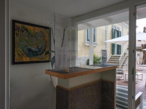 a glass counter in a room with a painting at Euvodia Luxury Rooms in Matera