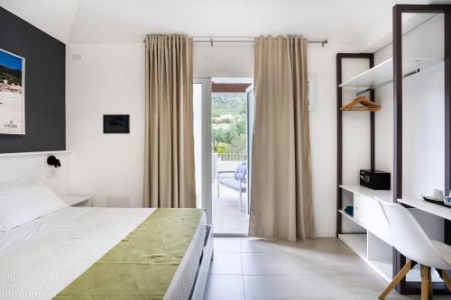 a bedroom with a bed and a balcony at Istedda Boutique Hotel in Solanas