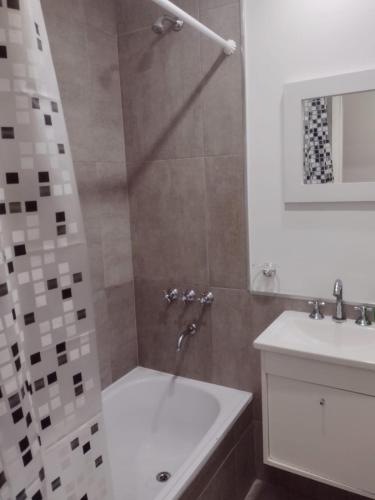 a bathroom with a shower with a tub and a sink at DTo CÉNTRICO LOBOS 1 B in Lobos