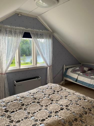 a bedroom with a bed and a window at Sommarstugan in Äspered