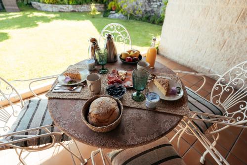 uma mesa com comida e bebidas em cima em Os Migueliños em Catoira