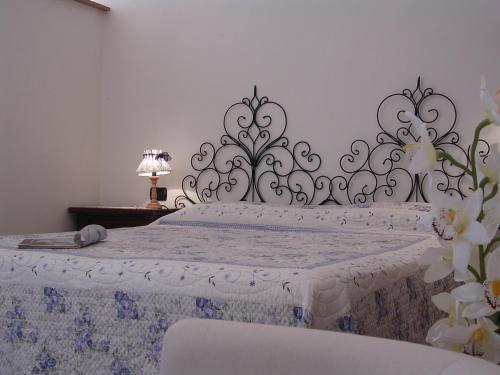 a bedroom with a white bed with a black and white headboard at Casa Vacanze Del Pescatore in Passignano sul Trasimeno