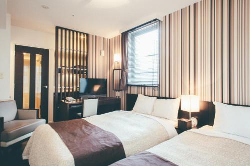 Posteľ alebo postele v izbe v ubytovaní Kuretake Inn Premium Hamamatsucho