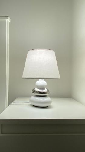 a white lamp sitting on top of a drawer at Casa Valentina 1 in Perugia