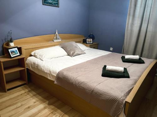 a bedroom with a bed with two towels on it at Adriatic Oasis Apartments in Preko