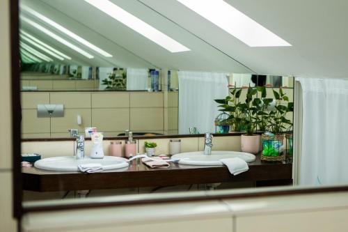 a bathroom with two sinks and a large mirror at Vila Ava in Zaprešić