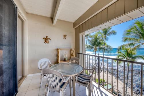 a balcony with a table and chairs and a view of the beach at Kona Bali Kai #418 in Kailua-Kona