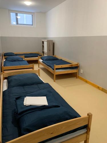 a room with three bunk beds and a window at U Marty in Jaworzno