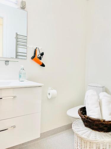 a white bathroom with a toilet and a mirror at Scandinavian Apartment Hotel - Tobaksgården - 2 room apartment in Horsens