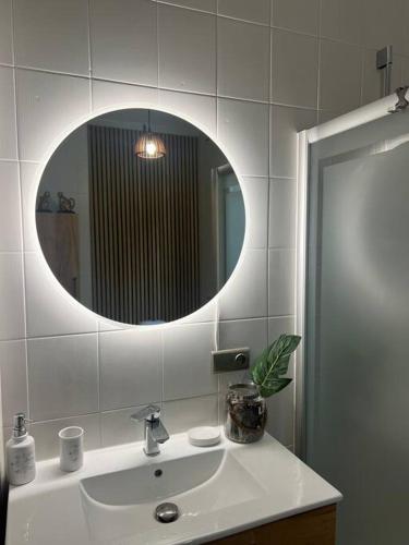 a bathroom with a sink and a mirror at Siedlisko Musialove nad jeziorem 8 osob in Łężce