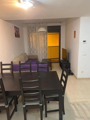 a dining room and living room with a table and chairs at Apartamento in Lloret de Mar