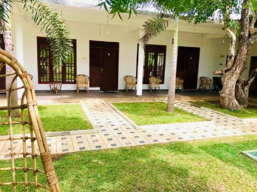 a courtyard of a house with palm trees at Sigiriya Green Garden Home in Sigiriya