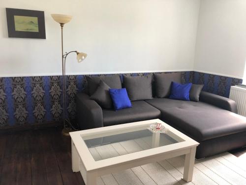 a living room with a couch and a coffee table at Ferienwohnung Ostwind in Schüller