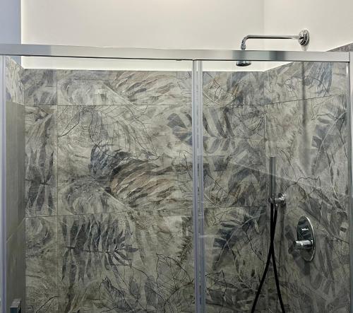 a shower with a glass door in a bathroom at La Corte 25 in Marsala