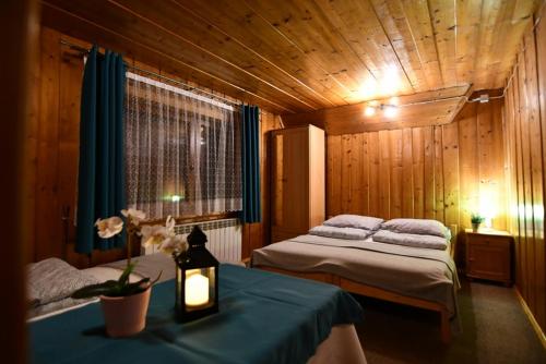 a bedroom with two beds and a table with a lamp at Kwatery u Malika-blisko do term Szaflary i Gorący Potok-rabaty in Szaflary