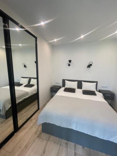 a bedroom with a bed and a large mirror at Residential complex Parkland in Kyiv