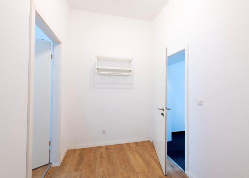 an empty room with a window and a air conditioner at Stay and Work Apartment - 8 single beds - central in Gronau