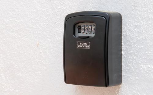 a black remote control attached to a wall at Stay and Work Apartment - 8 single beds - central in Gronau