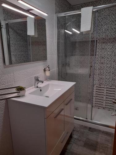 a white bathroom with a sink and a shower at Atlantico in Geres