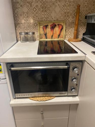 a microwave oven with a box of cooking utensils at Corali in Menídion