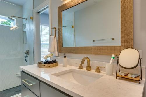 a bathroom with a sink and a mirror at Modern Oklahoma City Home with Private Backyard! in Oklahoma City