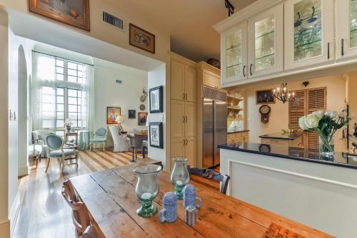 a kitchen and living room with a wooden table at Elegant French Patio Home with Private Pool in Houston